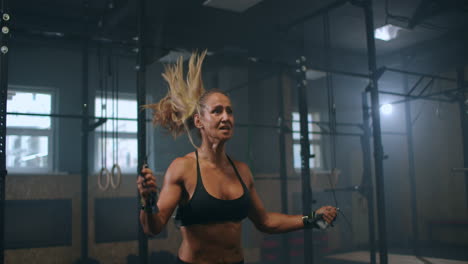 Strong-muscular-young-woman-rope-skipping-as-warm-up.-Fitness-concept.-Young-slim-woman-jumping-with-skipping-rope-in-gym.-Close-up-of-female-feet-jumping-in-mid-air-whilst-using-skipping-rope.